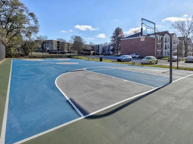Basketball court with buildings and cars exterior at Willowtree Apartments & Tower in Ann Arbor Student Accommodation