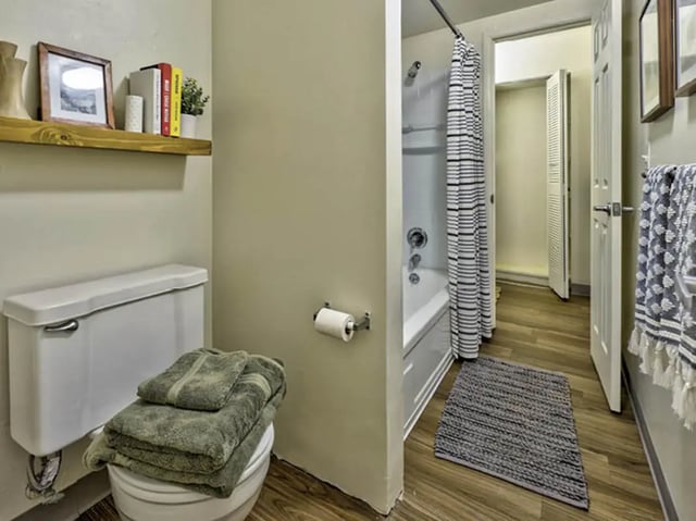 Toilet tub shower with striped curtain bathroom at Willowtree Apartments & Tower in Ann Arbor Student Accommodation