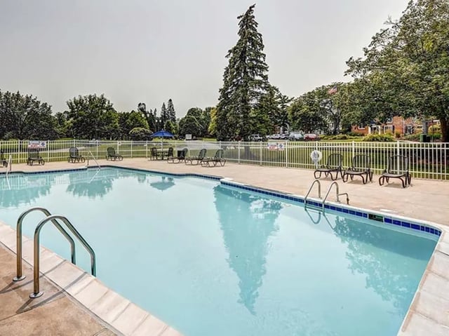 Pool with lounge chairs and tables swimming area at Willowtree Apartments & Tower in Ann Arbor Student Accommodation