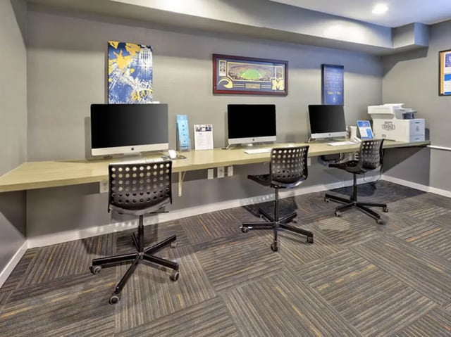 Computers and chairs at desk study area at Willowtree Apartments & Tower in Ann Arbor Student Accommodation