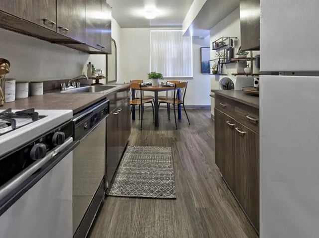 Stove cabinets sink table chairs kitchen at Willowtree Apartments & Tower in Ann Arbor Student Accommodation