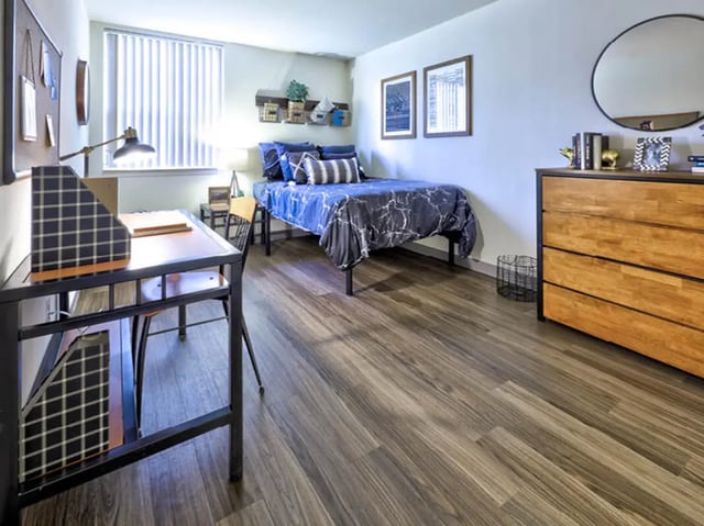 Desk bed dresser mirror circular bedroom at Willowtree Apartments & Tower in Ann Arbor Student Accommodation
