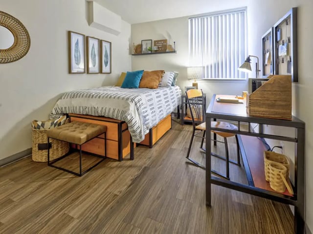 Bed desk chair ottoman storage baskets bedroom at Willowtree Apartments & Tower in Ann Arbor Student Accommodation