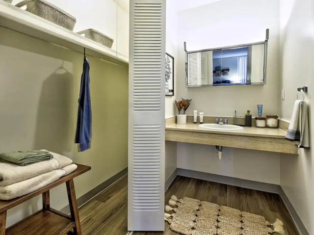 Closet with blue shirt and towels bathroom sink bathroom at Willowtree Apartments & Tower in Ann Arbor Student Accommodation