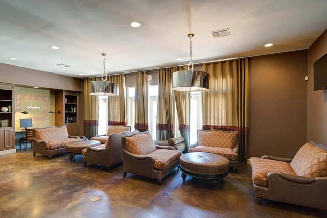 Chairs ottomans shelves and desk living room at The Arch at Troy in Troy Student Accommodation