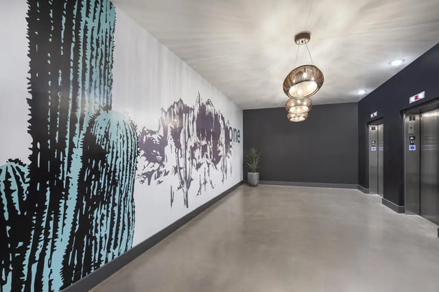 Wall mural with cactus elevators and plant hallway at Atmosphere Tempe in Tempe Student Accommodation