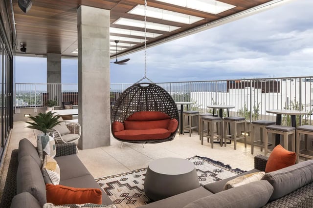 Sofa hanging chair coffee table outdoor seating area exterior at Atmosphere Tempe in Tempe Student Accommodation