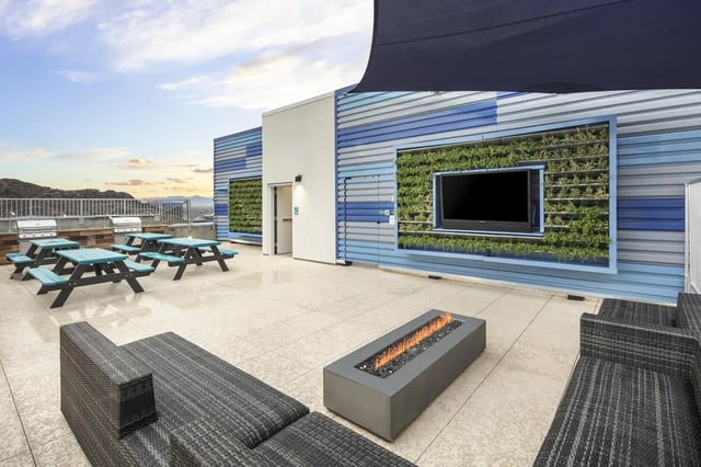 Picnic tables grills TV fire pit lounge seating exterior at Atmosphere Tempe in Tempe Student Accommodation