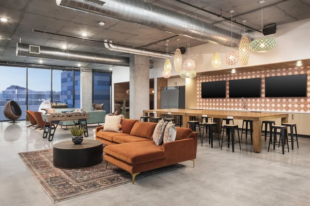 Orange sectional sofa foosball table living area at Atmosphere Tempe in Tempe Student Accommodation