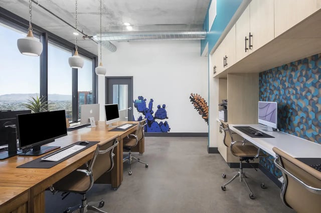 Wooden desks with computers and chairs study area at Atmosphere Tempe in Tempe Student Accommodation