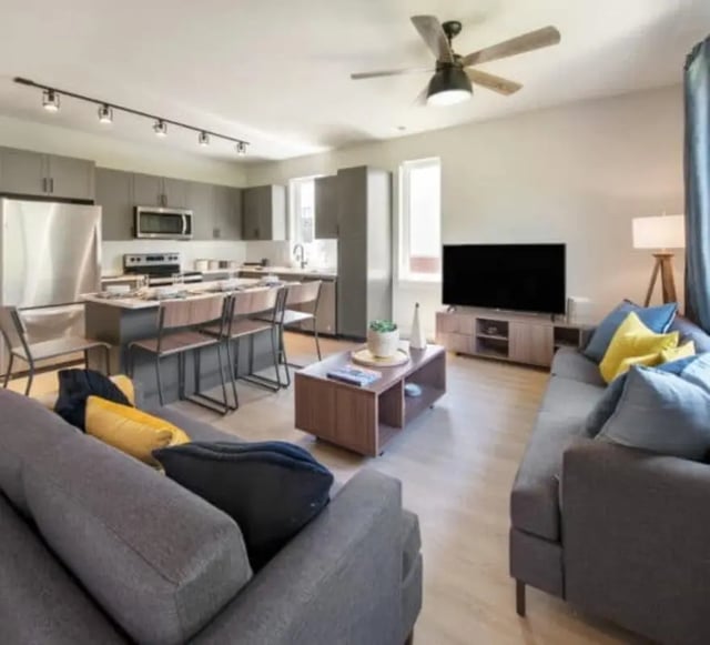 Modern kitchen island with stools living room living room at The Yards at Old State in State College Student Accommodation