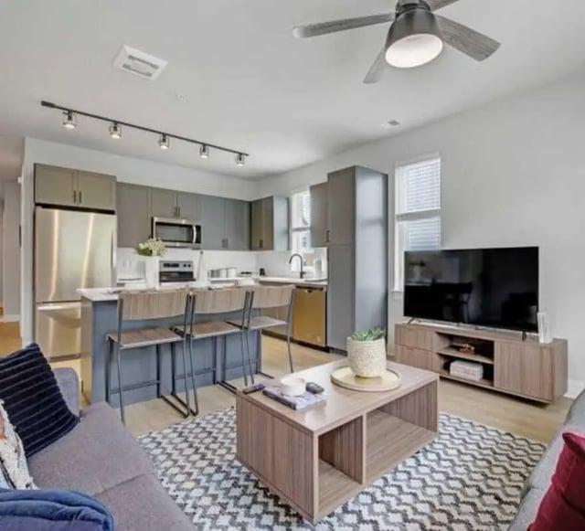Kitchen island bar stools and couch living room at The Yards at Old State in State College Student Accommodation