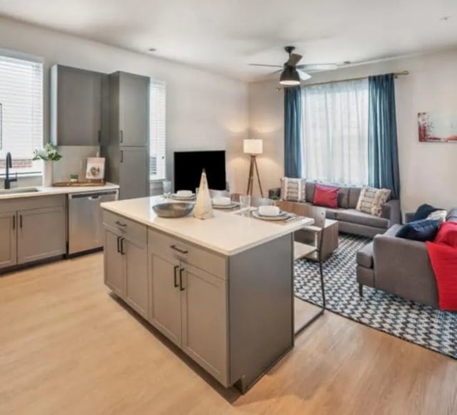 Kitchen island with seating and living area living room at The Yards at Old State in State College Student Accommodation