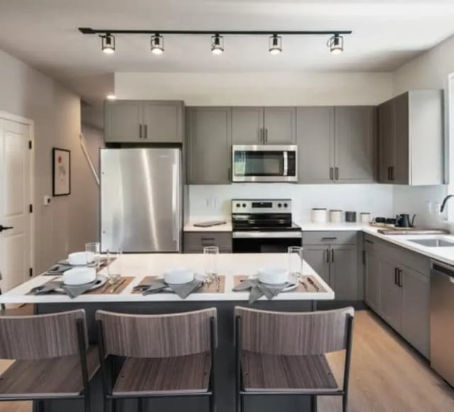 Modern kitchen island with chairs and appliances kitchen at The Yards at Old State in State College Student Accommodation