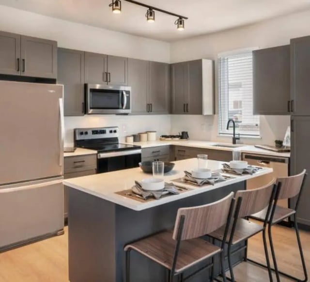 Modern kitchen with island and seating kitchen at The Yards at Old State in State College Student Accommodation
