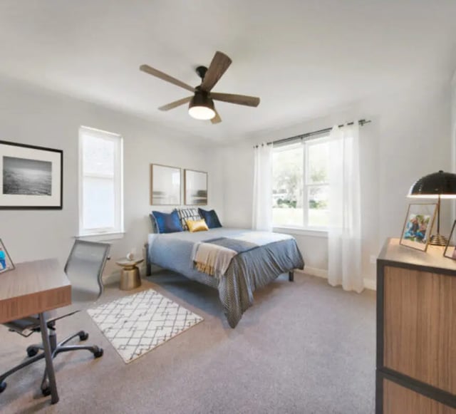 Bed desk chair rug and artwork bedroom at The Yards at Old State in State College Student Accommodation