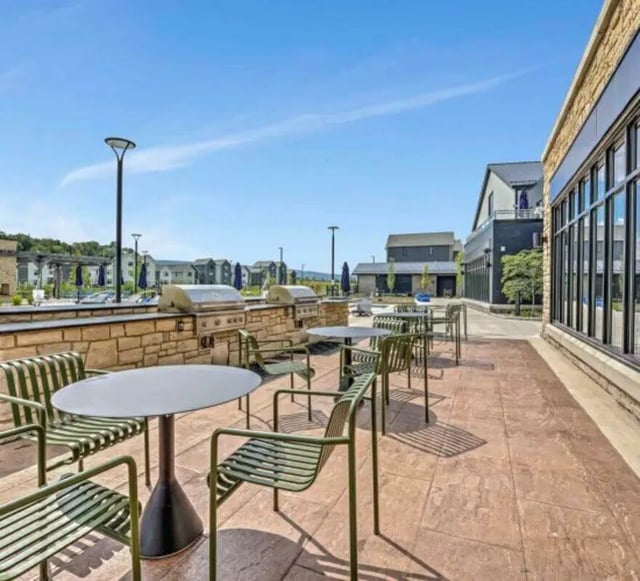 Grill stations tables chairs outdoor seating area exterior at The Yards at Old State in State College Student Accommodation