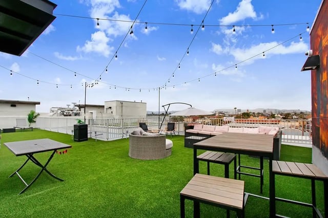 Rooftop lounge area with tables and seating exterior at USC Student Housing: Heritage 1275 in Los Angeles Student Accommodation