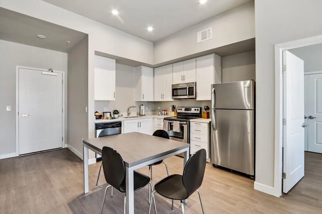 Modern kitchen with dining table and chairs kitchen at USC Student Housing: Heritage 1275 in Los Angeles Student Accommodation