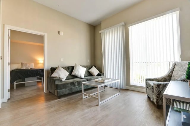 Sofa coffee table patterned chair living room bedroom at USC Student Housing: Heritage 1275 in Los Angeles Student Accommodation