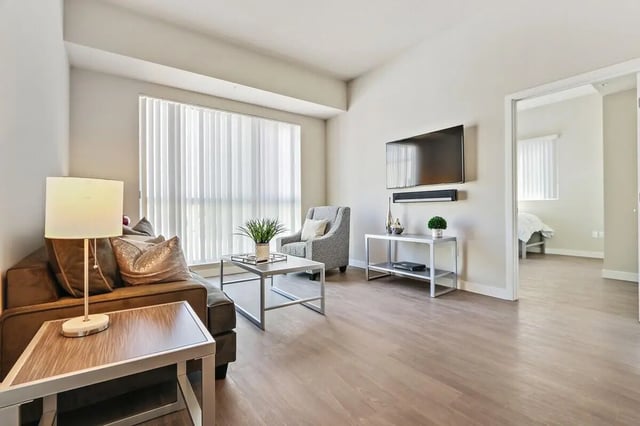 Sofa armchair tv and tables living room at USC Student Housing: Heritage 1275 in Los Angeles Student Accommodation