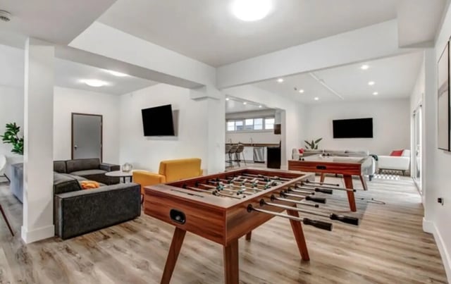 Foosball tables sofas and televisions common area at USC Student Housing: Heritage 2831 in Los Angeles Student Accommodation