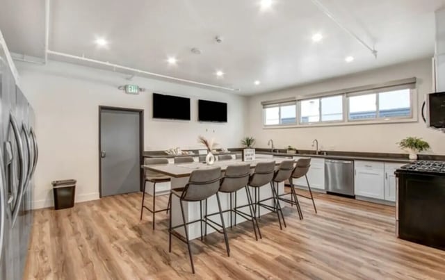 Kitchen island with bar stools and appliances kitchen at USC Student Housing: Heritage 2831 in Los Angeles Student Accommodation