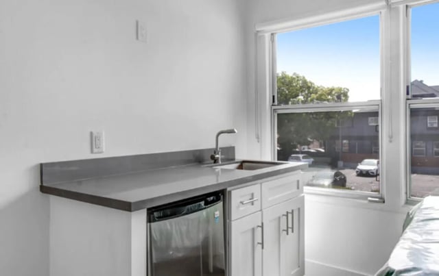 Sink mini fridge cabinets and window kitchen at USC Student Housing: Heritage 2831 in Los Angeles Student Accommodation