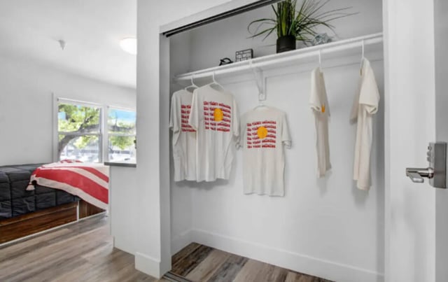 Closet with shirts and plant bedroom area at USC Student Housing: Heritage 2831 in Los Angeles Student Accommodation