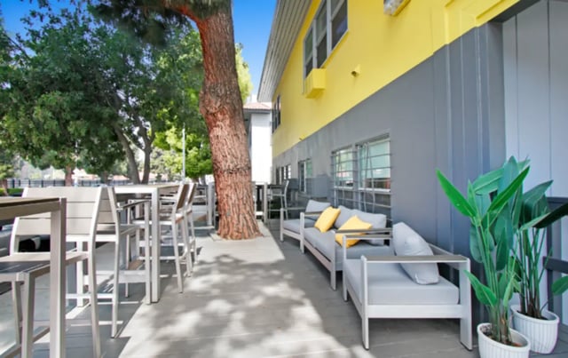 Outdoor seating lounge area and tables exterior at USC Student Housing: Heritage 2831 in Los Angeles Student Accommodation