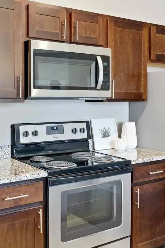 Microwave oven stove granite countertops kitchen at Midtown Stillwater Student Apartments in Stillwater Student Accommodation