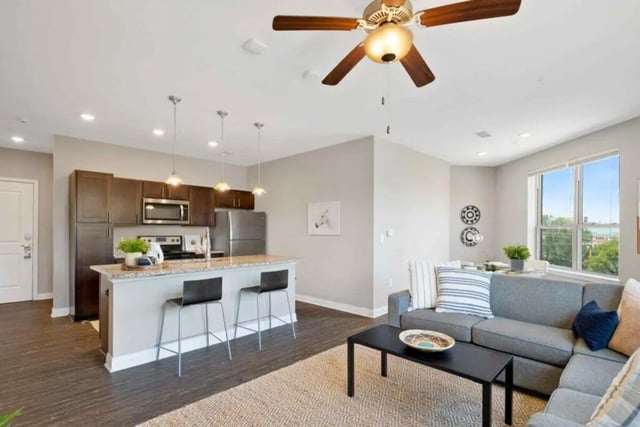 Modern kitchen island gray sofa coffee table living room at Midtown Stillwater Student Apartments in Stillwater Student Accommodation