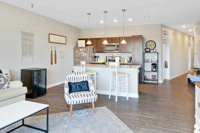 Kitchen island with stools and sofa living area at Midtown Stillwater Student Apartments in Stillwater Student Accommodation