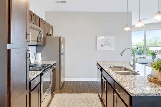 Kitchen with stainless steel appliances and island kitchen at Midtown Stillwater Student Apartments in Stillwater Student Accommodation
