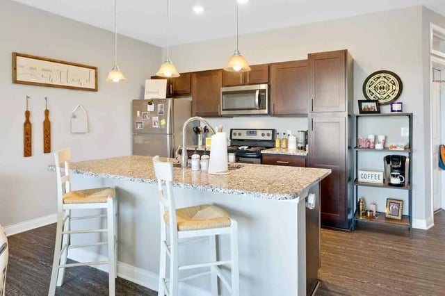 Island with stools stainless steel appliances kitchen at Midtown Stillwater Student Apartments in Stillwater Student Accommodation