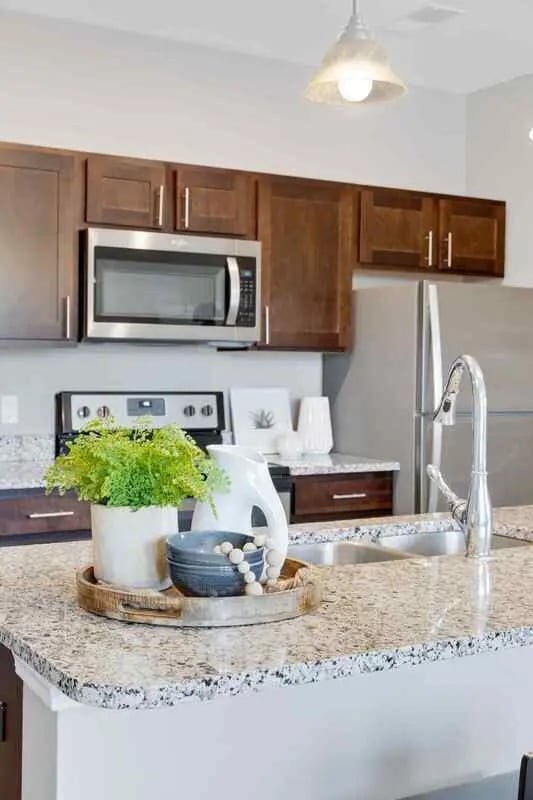 Kitchen with microwave sink and cabinets kitchen at Midtown Stillwater Student Apartments in Stillwater Student Accommodation