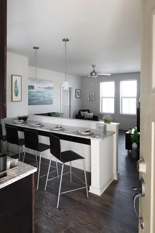 Bar with stools and living area kitchen at The Arrow Townhomes & Flats in Bozeman Student Accommodation