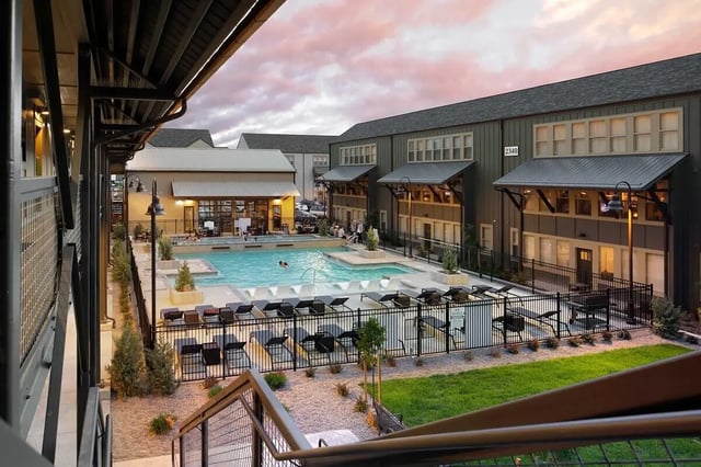 Pool deck with lounge chairs exterior at The Arrow Townhomes & Flats in Bozeman Student Accommodation