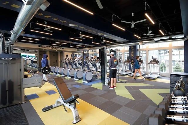 Gym equipment people treadmills ellipticals weights gym at The Arrow Townhomes & Flats in Bozeman Student Accommodation