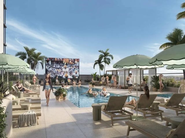 Pool with lounge chairs large screen and people Playing area at Rambler Tempe Apartments in Tempe Student Accommodation