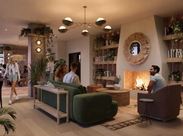 Green sofa fireplace shelves mirror plants living room at Rambler Tempe Apartments in Tempe Student Accommodation