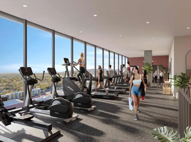 Gym with treadmills ellipticals and people exercising gym at Rambler Tempe Apartments in Tempe Student Accommodation