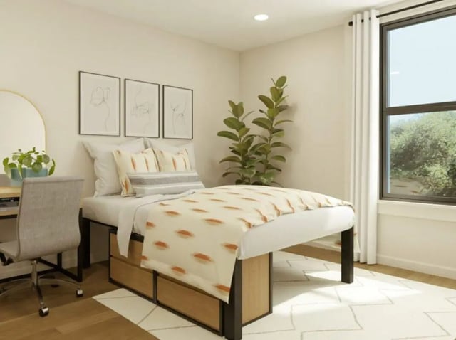 Bed desk chair artwork plant bedroom at Rambler Tempe Apartments in Tempe Student Accommodation