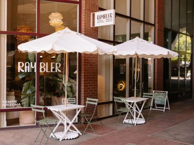Outdoor seating with umbrellas and tables exterior at Rambler Tempe Apartments in Tempe Student Accommodation