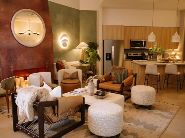 Leather chairs ottoman fireplace lighting kitchen living room at Rambler Tempe Apartments in Tempe Student Accommodation