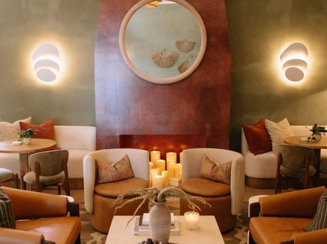 Chairs couches candles mirror above fireplace Living Room at Rambler Tempe Apartments in Tempe Student Accommodation