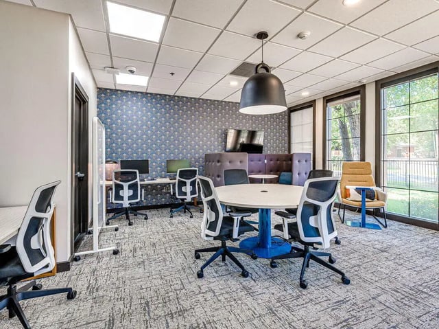 Desks chairs and round table study area at The Flats at Norman in Norman Student Accommodation