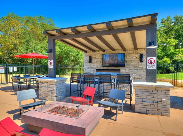 Pergola with seating fire pit and outdoor kitchen exterior at The Flats at Norman in Norman Student Accommodation