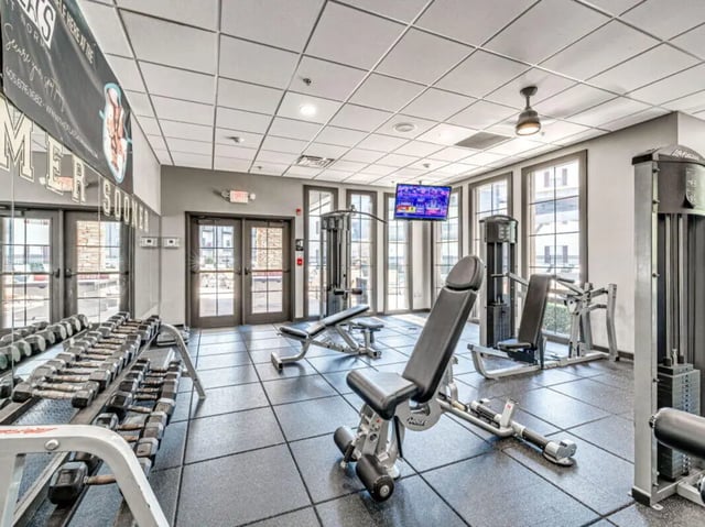 Weight racks benches and machines gym at The Flats at Norman in Norman Student Accommodation