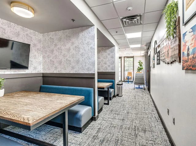 Study booths with tables and chairs lounge area at The Flats at Norman in Norman Student Accommodation